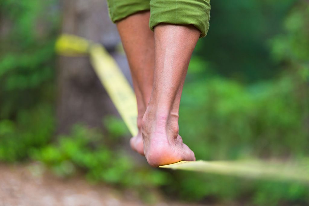 Person balancing on a tightrope.