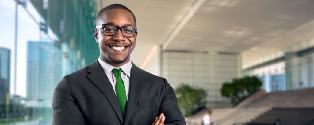 a businessman standing with his arms crossed and smiling